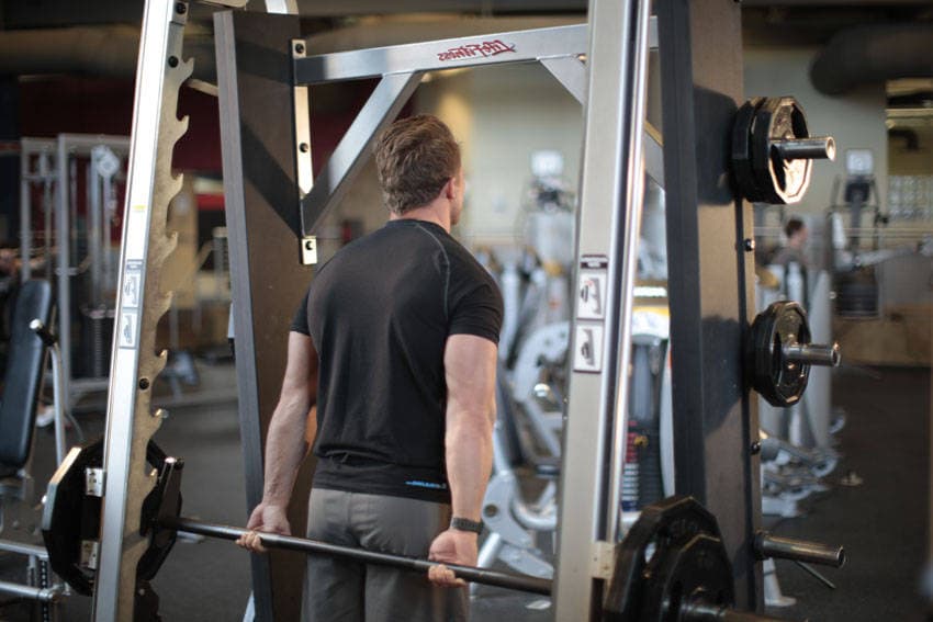 Smith Machine Behind the Back Shrug — start position