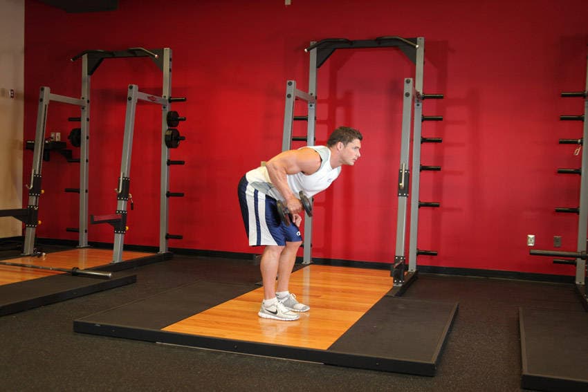 Standing Bent-Over One-Arm Dumbbell Triceps Extension — start position
